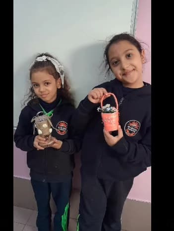 Grade Two working on their recycling project using empty jars and boxes